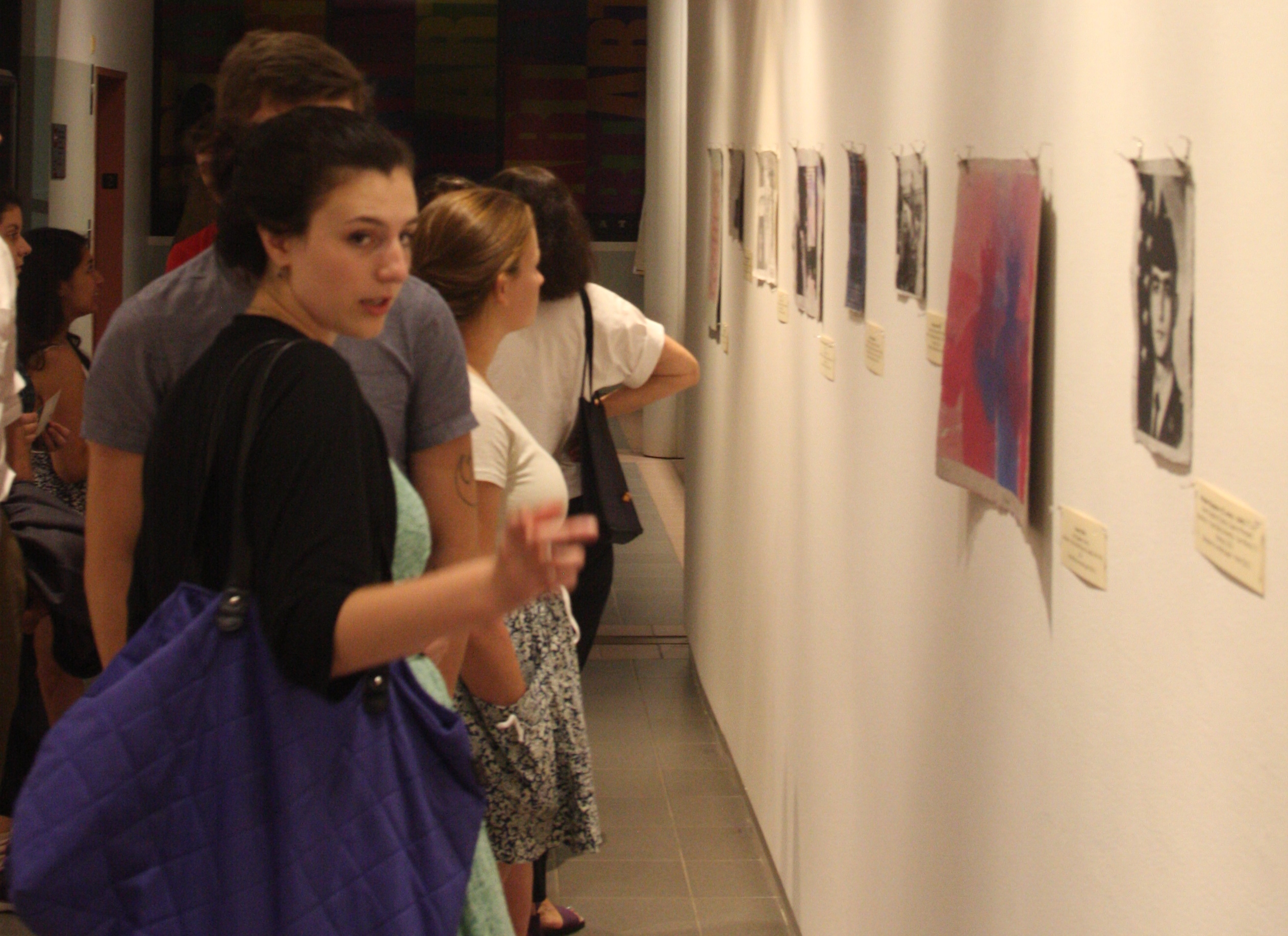 Student looks at Combat Paper art